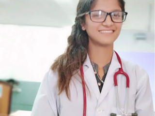 Dr. Sonu Adhikari - Treasurer in white labcoat